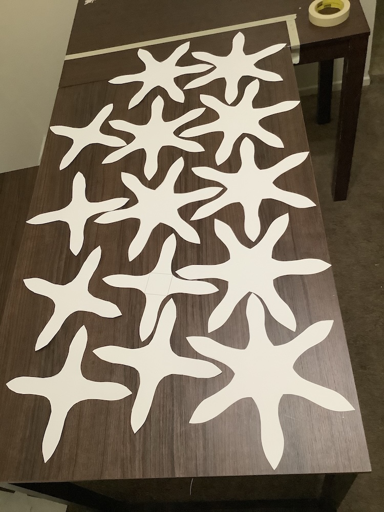 A student is figuring out their nesting plan by laying out their disassembled prototype. The polyhedron was a truncated octahedron (6 hexagons and 8 squares). kathia-nesting-plan-smaller