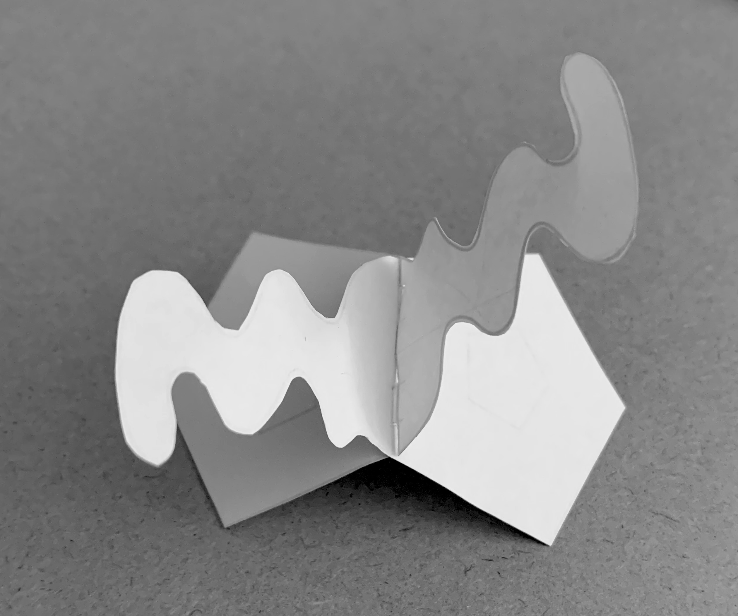 Above is a test sample of an interlock. This is not a practical design, just a test of its strength, fit, finish and dimensions. Slit cuts with small reliefs were made - rather than slots - which accounts for the slight distortion of the extension on the right. interlock-sample-graytone