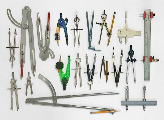 A sampling of differing compasses; most are bow compasses with wheel adjusters. Compasses